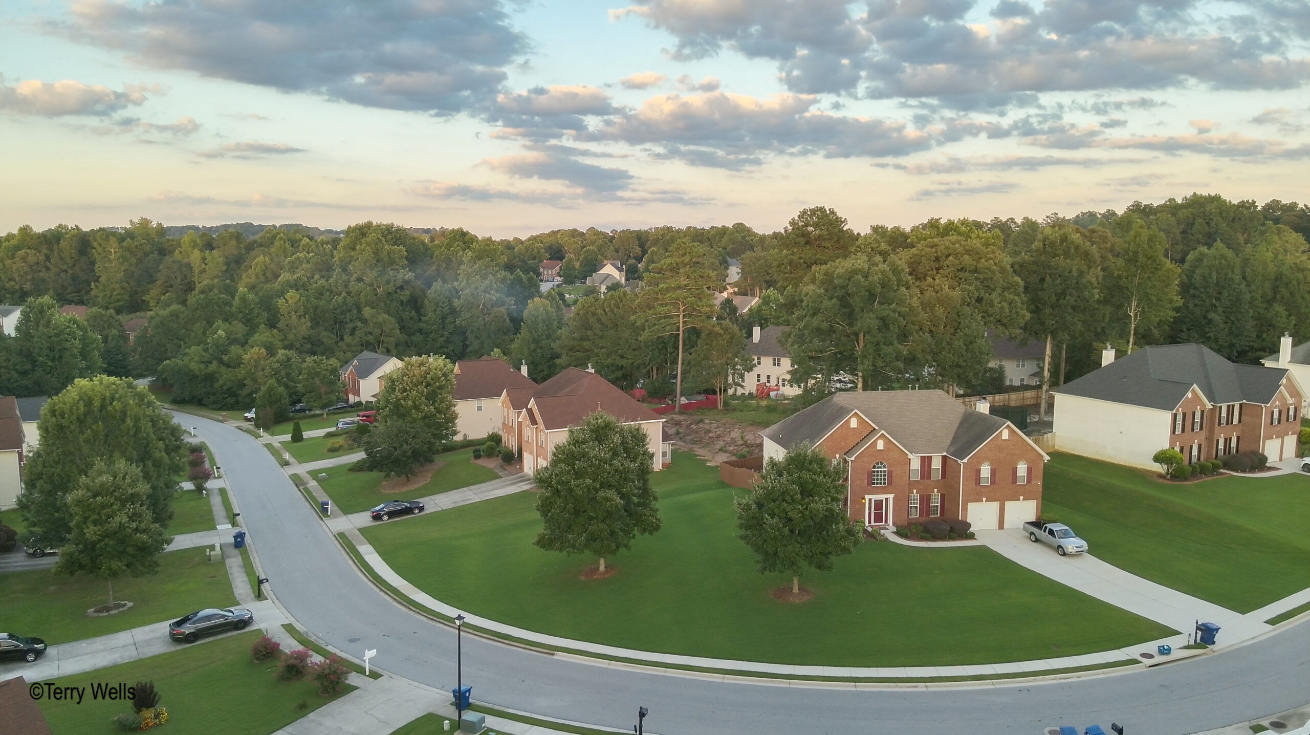 Aerial shop of defined curve in North Metro Atlanta neighborhood and deep green grass.