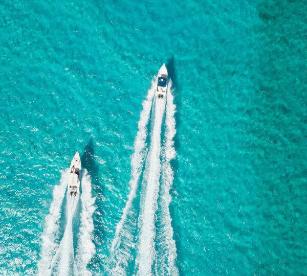 aerial view of two white speedboats in aqua water