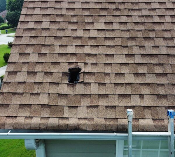 Picture of Roof with hole in it caused by fallen satellite dish